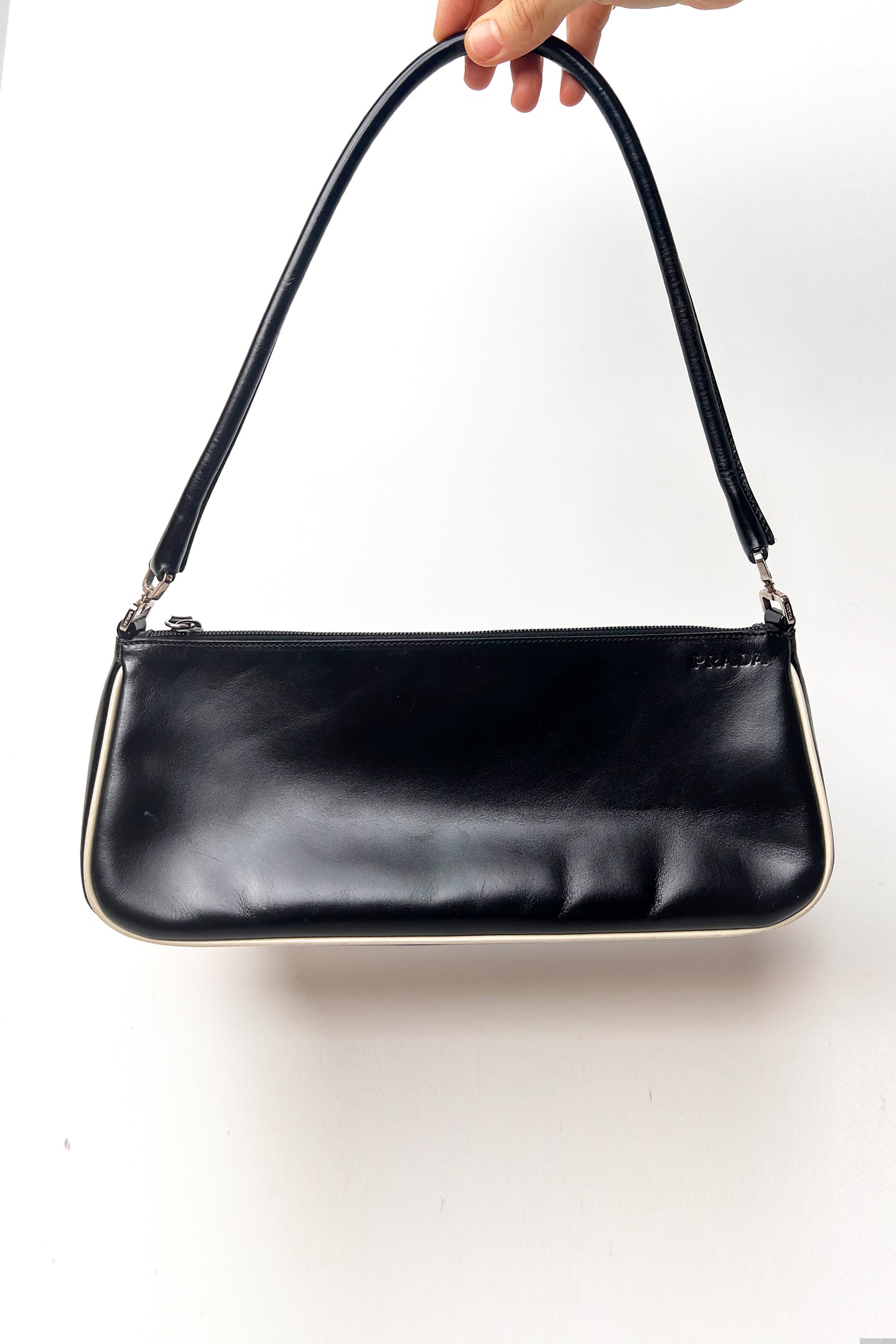 Vintage 2000s black Prada leather shoulder bag with white trims