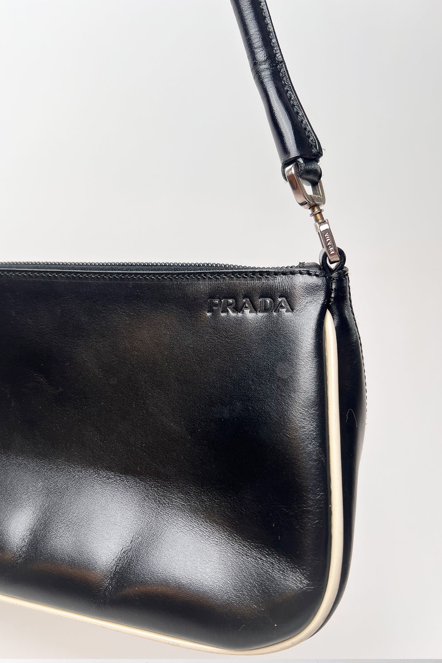 Vintage 2000s black Prada leather shoulder bag with white trims